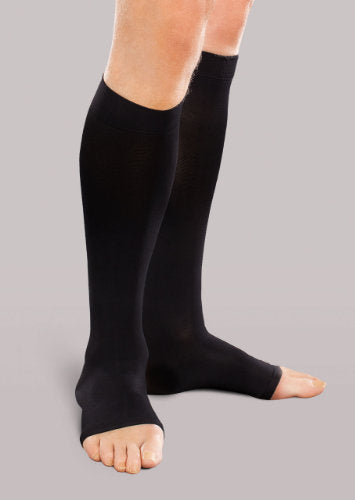 Man wearing his Therafirm EASE Opaque Unisex Open Toe knee high 30-40 mmHg compression stockings in the color Black