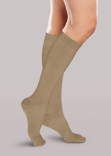 Lady wearing her Therafirm Women's Chevron-Styled Trouser Socks in the compression level 20-30 mmHg color khaki