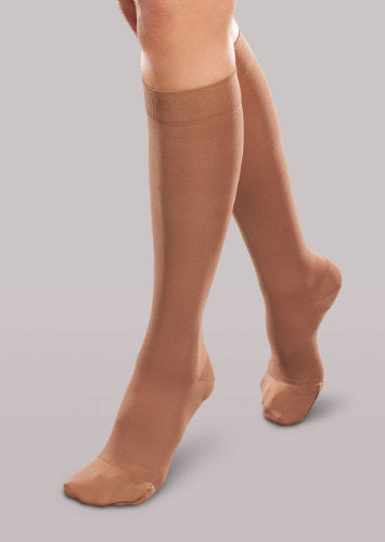 Lady wearing her Therafirm EASE Opaque Women's knee high 15-20 mmHg compression stockings in the color bronze