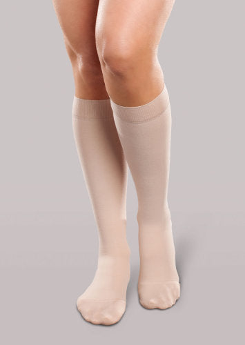 Lady wearing her Therafirm EASE Opaque Women's knee high 15-20 mmHg compression stockings in the color natural