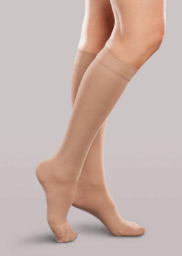 Lady wearing her Therafirm EASE Opaque Women's knee high 15-20 mmHg compression stockings in the color sand