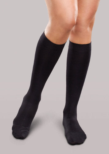 Lady wearing her Therafirm EASE Opaque Women's knee high 15-20 mmHg compression stockings in the color black