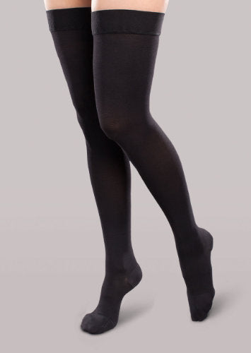 Lady wearing her Therafirm EASE Opaque Women's thigh high 30-40 mmHg compression stockings in the color black