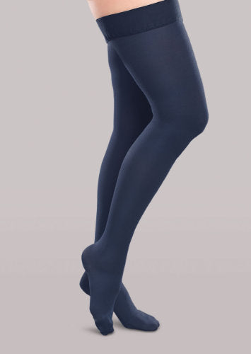 Lady wearing her Therafirm EASE Opaque Women's thigh high 20-30 mmHg compression stockings in the color navy