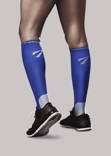 Woman wearing her Therasport Athletic Recovery Compression Socks in the color Blue.