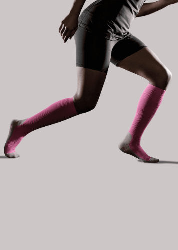 Woman wearing her Therasport Athletic Recovery Compression Socks in the color Pink.