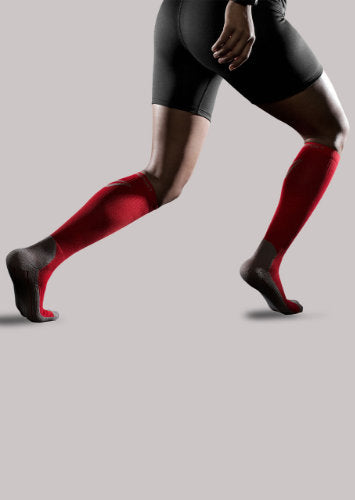 Woman wearing her Therasport Athletic Performance Compression Socks in the color Red.