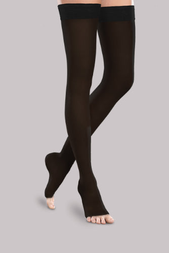 Lady wearing her Ease Sheer 30-40 mmHg compression thigh-high open-toe stocking by Therafirm in the color black