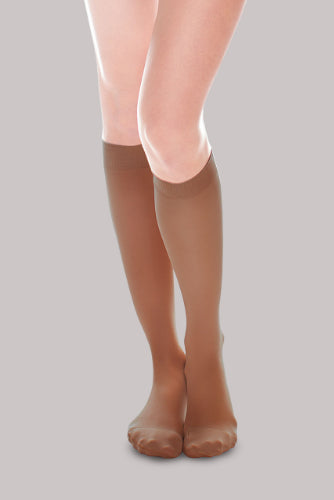 Lady wearing her Ease Sheer 20-30 mmHg compression stocking by Therafirm in the color bronze