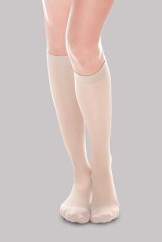 Lady wearing her Ease Sheer 20-30 mmHg compression stocking by Therafirm in color natural