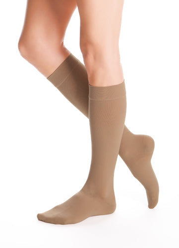 Lady wearing her Duomed Advantage 30-40 mmHg Compression Stockings in the color Almond