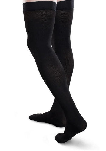 Guy wearing his thigh high Core-Spun 30-40 mmHg Compression Socks in the color Black