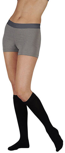Lady wearing her Juzo Soft 30-40 mmHg Closed Toe Knee High Compression Stocking in the Color Beige