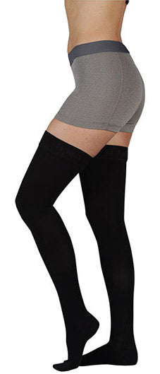 Lady wearing her Juzo Soft Closed Toe Thigh High Compression Stockings in the color Black | Compression Care Center
