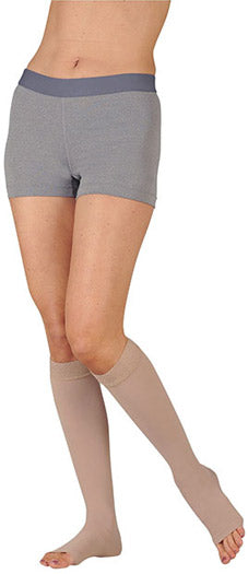 Lady wearing her Juzo Soft Open Toe Knee High Compression Stockings with a Silicone Dot Band