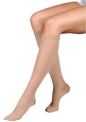 Lady wearing her Juzo Basic Knee High Closed Toe 15-20 mmHg Compression Stockings in the Color Beige 4410ADFF14