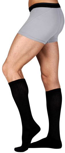 Guy wearing his Juzo Basic Casual Knee High 20-30 mmHg Compression Socks in Black (4701AD10)