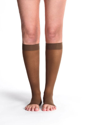 Female leg wearing Sigvaris 782CO Sheer Open Toe Knee High Compression Stockings in the color Mocha