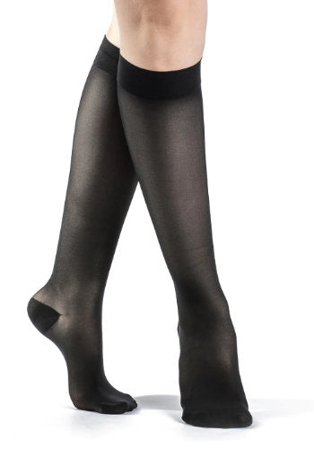 Female legs wearing Sigvaris 783 Sheer Knee High Compression Stockings in the color Black