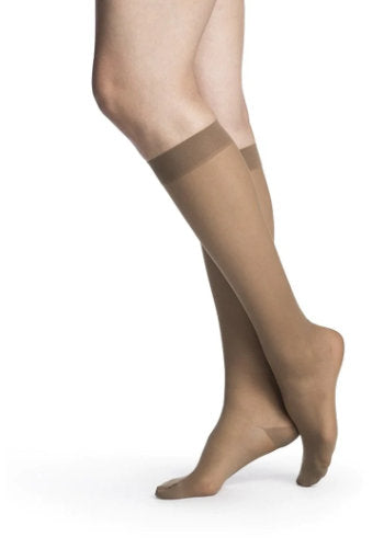 Female legs wearing Sigvaris 782 Sheer Knee High Compression Stockings in the color Cafe