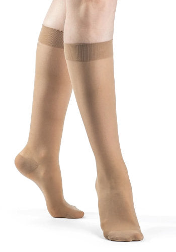 Female legs wearing Sigvaris 783 Sheer Knee High Compression Stockings in the color Golden