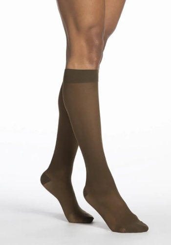 Female legs wearing Sigvaris 782 Sheer Knee High Compression Stockings in the color Mocha