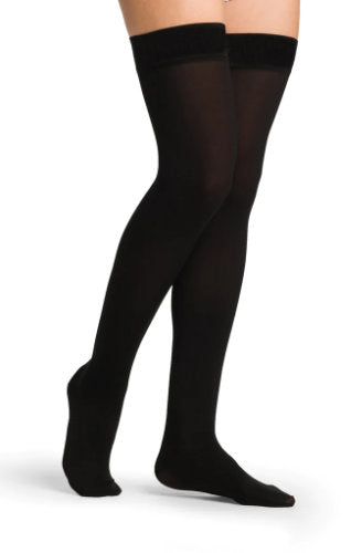 Lady wearing her Sigvaris 863N Opaque Thigh High with Silicone Top Band in the color Black