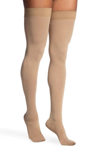 Lady wearing her Sigvaris 863N Opaque Thigh High with Silicone Top Band in the color Light Beige