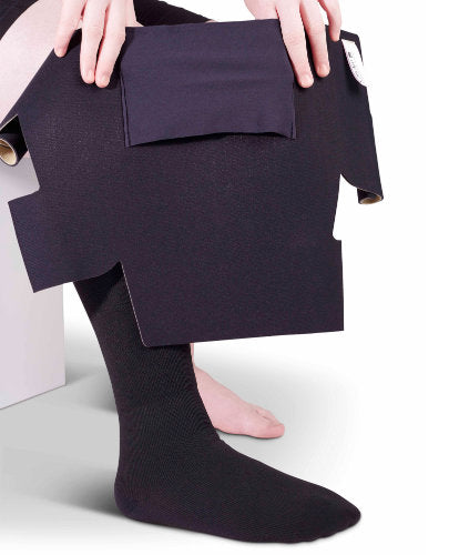 Lady holding up her Circaid JuxtaLite HD velcro compression wrap in the color Beige. 