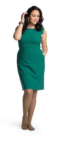 Woman in a green dress wearing her Sigvaris 782P compression pantyhose in the color Cafe