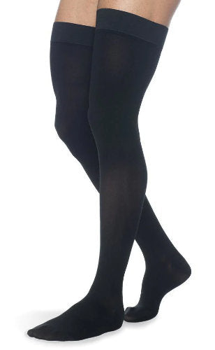 Man wearing his Sigvaris Secure Thigh High Compression Stockings in Black