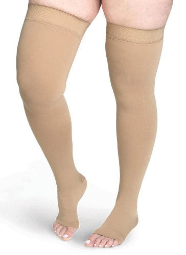 Lady wearing Sigvaris Secure Thigh High compression stockings with an open toe in the color Beige