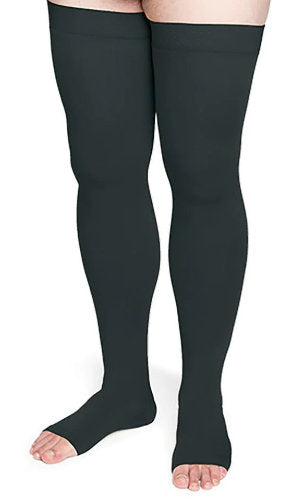 Lady wearing Sigvaris Secure Thigh High compression stockings with an open toe in the color Black