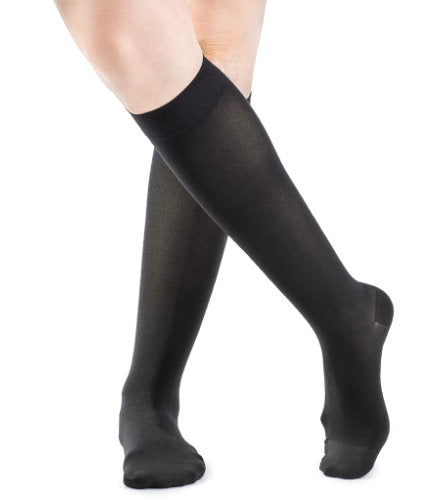 Ladies leg wearing the Sigvaris 843C Medical Compression Knee High Stockings in the color Black