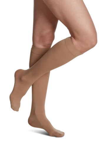 Female wearing her Sigvaris 841C Soft Opaque Compression Stockings in the color Chai