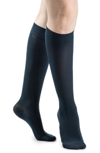 Female wearing her Sigvaris 841C Soft Opaque Compression Stockings in the color Midnight Blue