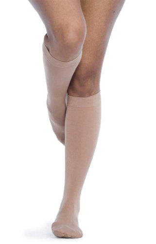 Female wearing her Sigvaris 841C Soft Opaque Compression Stockings in the color Pecan