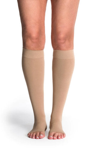Lady wearing her open-toe 841CO Sigvaris Soft Opaque Compression Stockings in the color Chai