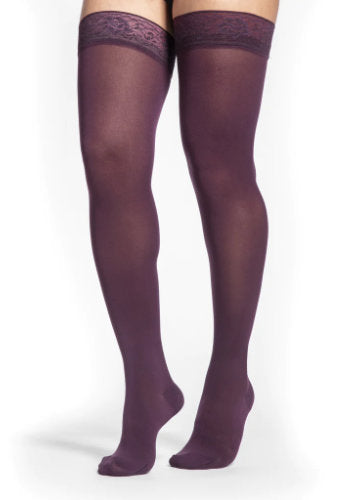 Lady wearing her Sigvaris Soft Opaque 841N thigh high closed toe stockings in the color Mulberry