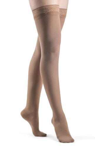 Lady wearing her Sigvaris Soft Opaque 841N thigh high closed toe stockings in the color Pecan