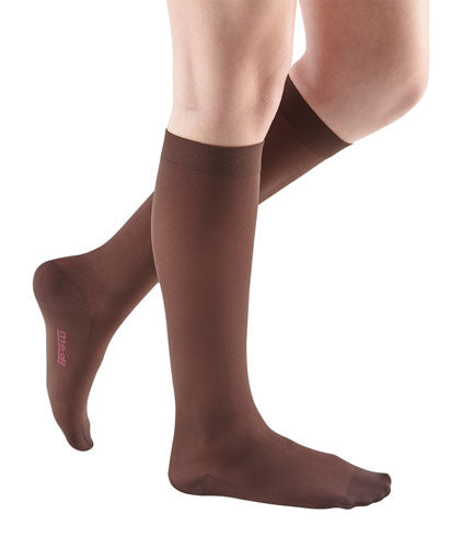 Female leg showcasing the Mediven Comfort Closed Toe Knee High in the color Chocolate