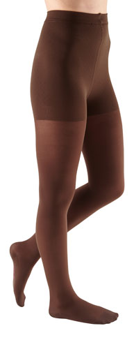 Lady wearing her Mediven Comfort Waist High Compression Stockings in the color Chocolate