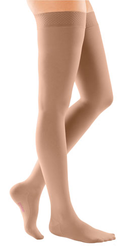 Woman's leg wearing the Medi Comfort Thigh High Compression Stocking with the Silicone Dot Band in the color Natural