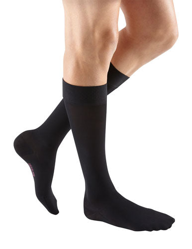 Male wearing Mediven Plus Knee High Closed Toe with Silicone Dot Band 30-40 mmHg Compression Stockings in the color Black