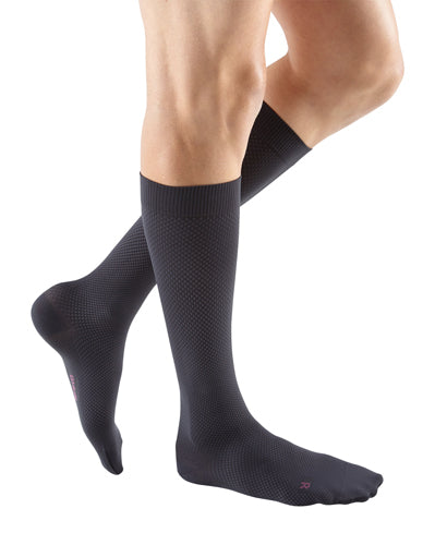 Man wearing his Mediven for Men Select Dress 15-20 mmHg Compression Socks in the Color Grey