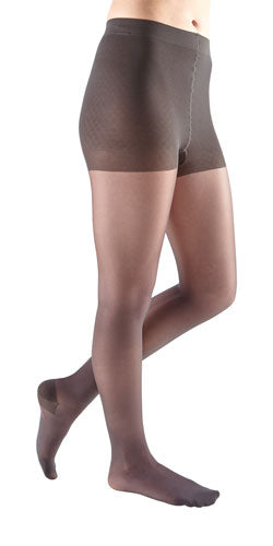 Lady wearing her Mediven Sheer & Soft 15-20 mmHg Waist High Compression Stockings in the color Charcoal