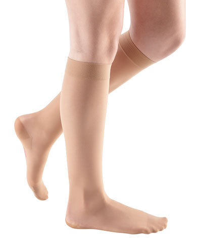 Photo of a ladies legs wearing Mediven Sheer and Soft 30-40 mmHg Compression Knee High Stockings in the Color Toffee