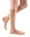 ladies legs wearing a pair of natural colored Mediven Sheer & Soft compression stockings with closed toe