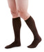 man wearing a pair of brown knee-high compression socks the Mediven for Men Classic sock has a thin verticle pinstripe design
