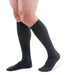 man wearing a pair of grey knee-high compression socks the Mediven for Men Classic sock has a thin verticle pinstripe design